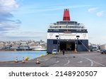 Small photo of Ferry boat loading or unloading in seaport of Piraeus near Athens, Greece, Europe. Large ferryboat docked in sea harbor, big ship at port pier. Concept of car transportation, tourism, port and travel