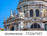 Basilica di Santa Maria della Salute (Saint Mary of Health), Venice, Italy. Statues on facade of Baroque Catholic church, landmark of Venice. Scenery of Italian architecture in Punta della Dogana.