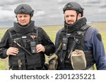 Small photo of Sappers Alexander and Mikhail clear land from possible landmines before workers fix power line destroyed during Russian invasion near village of Kamyanka of Kharkiv Region of Ukraine on May 10, 2023