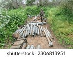 Small photo of Sapper Ihor poses with unexploded munition collected by de-mining unit of National Guards of Ukraine before they will be destroyed seen in near Kherson in Ukraine on May 22, 2023