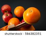 Small photo of The idiom, comparing apples and oranges, refers to the differences between incomparable or incommensurable items. The concept is illustrated by 2 groups of apples and oranges on a balance scale