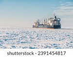 Small photo of Winter shipping. Big cargo ships in frozen ice sea fairway