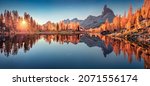 Small photo of Panoramic autumn view of popular tourist destination - Federa lake among red larch trees. Spectacular sunrise in Dolomite Alps. Colorful morning scene of Italy. Beauty of nature concept background.