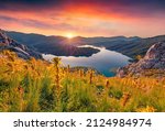 Superb sunrise on Bovilla Lake, near Tirana city located. Spectacular spring landscape with blooming yellow flowers. Fantastic outdor scene of Albania, Europe. Beauty of nature concept background.