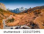 Spectacular autumn view from flying drone top of Falzarego pass. Sunny autumn scene of Dolomite Alps with Torre Grande Cima Ovest peak on background, Italy, Europe. Traveling concept background.