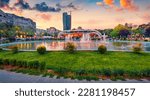 Small photo of Wonderful spring view of Scanderbeg Square with illuminated fountain. Beautiful sunset in capital of Albania - Tirana. Traveling concept background.