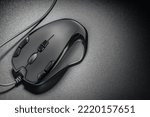 Black professional gaming wired gaming mouse on a simple black background