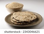 Small photo of Soft flat bread made of pearl millet flour. with pearl millet bowl. Commonly called bajra roti in India