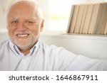 Closeup portrait of happy pensioner smiling at camera.