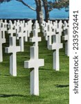 Small photo of The solemnity of Colleville American Cemetery in Normandy, where rows of white crosses pay tribute to the fallen soldiers of World War II.