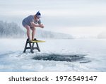 Fuunny overweight, retro swimmer about to jump into ice hole in the lake, with copy space 