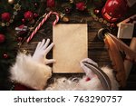 Close up of Santa Claus hands writing letter on Worden desk with copy space