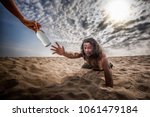 thirsty man in desert try to catch water bottle