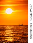 Small photo of Bright sunset with large yellow sun overr the sea surface in Santa Suzanna, Spain