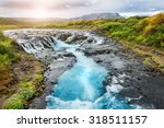 Beautiful Bruarfoss waterfall with turquoise water at sunset. South of Iceland