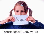 Small photo of Manipulation, fake facial expression, fake emotion and psychological trouble. Beautiful young girl with fake banner with fake smile.