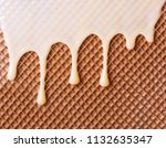 Small photo of White hot chocolate on the wafer. Waffle covered with condensed milk close-up. White hot chocolate spreads on the wafer.