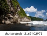 Cliffs and black sand beach in Dominica