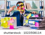 Businessman with reminder notes in multitasking concept