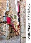 Small photo of Toledo, Spain - June 30, 2022. Tourists walking through Silleria street, a typical street of Toledo downtown. Toledo, Castilla La Mancha, Spain.