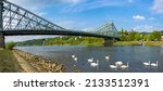 Small photo of Dresden, Saxony, Germany: The Blue Wonder Bridge seen from the district of Blasewitz with white swans that frolic on the Elbe river.