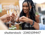 Small photo of Friends Toasting Champagne with Smiling African-American Woman - Champagne flutes toast in restaurant courtyard, woman joins.
