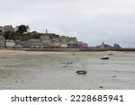 Small photo of beached boats stranded in quicksand by the sea at low tide