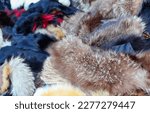 Small photo of background of many scraps of animal fur stoles for sale in the luxury furrier
