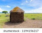 Small photo of Maasai ’s shelter, circular shaped thatch house made by women using timber poles as framework, interwoven with branches, spread with mud grass cow dung sticks on walls in Tanzania, East Africa