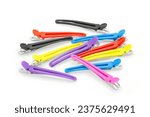 Closeup of colorful duckbill hair clips on white background. Hair styling accessories in different colors, used in salon or at home to clamp sections and style hair. 