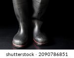 Black Rubber Boots Against A...