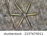 A hunter has his empty cartridge cases arranged in a star on the wooden board of his hunting pulpit at the end of the hunt.