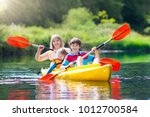 Child With Paddle On Kayak....