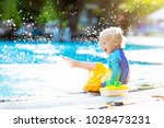 Baby With Toy Boat In Swimming...