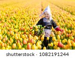 Child In Tulip Flower Field...