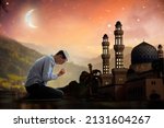 Small photo of Ramadan Kareem greeting. Man with prayer beads in mosque. Muslim male praying. Quran reading and pray. End of fasting. Hari Raya day. Eid al-Fitr celebration. Breaking of holy fast day.
