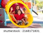 Small photo of Kids on playground. Children play outdoor on school yard slide. Healthy activity. Summer vacation fun. Child playing in sunny park. Kid having fun on colorful slide.