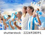 Small photo of Argentina football supporter on stadium. Argentinian fans on soccer pitch watch team play. Group of supporters with flag and national jersey cheering for Argentina. Championship game. Vamos Argentina