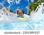 Child in swimming pool floating ...