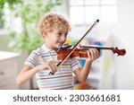 Child playing violin. remote...
