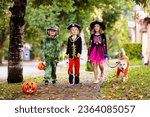 Small photo of Kids trick or treat in Halloween costume. Children in colorful dress up with candy bucket on suburban street. Little boy and girl trick or treating with pumpkin lantern. Autumn holiday fun.