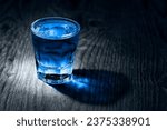 shot of blue drink on old wooden surface