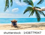 Back view of young beautiful woman sunbathe and relax on tropical beach with copy space. Summer vacation concept                  