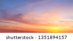 Real majestic sunrise sundown sky background with gentle colorful clouds without birds. Panoramic, big size