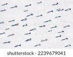 Small photo of Ski resort. Aerial view of skiers. Winter sports. Snow slope in the mountains for sports. Group training. Exercise with friends. winter landscape from a drone.