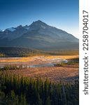 Small photo of Mountain landscape at dawn. Sunbeams in a valley. Rivers and forest in a mountain valley at dawn. Natural landscape with bright sunshine. High rocky mountains. Banff National Park, Alberta, Canada.