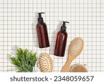 Brown shower gel dispensers, wooden combs for hair care. Round wooden brush for anticellulite massage with natural bristles, top view.