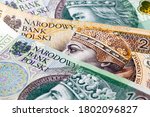 Small photo of new banknote worth one hundred and two hundred Polish zlotys, close-up of cash Polish money