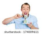 Small photo of Closeup portrait of greedy, evil young ceo man in blue shirt eating green cash dollars from plate, isolated on white background. Negative emotion, facial expression feelings. Financial avarice concept