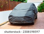 Covered car on a yard . Car Cover Carport Parking 